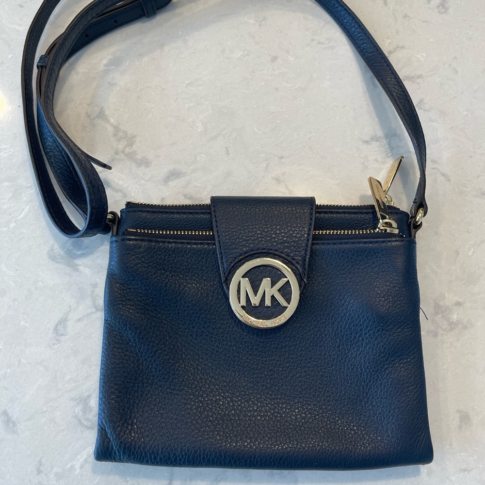 Michael Kors navy crossbody with gold accents.
